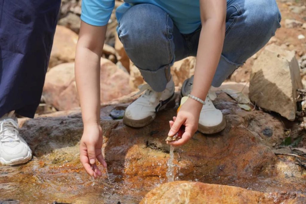 a sip of the refreshing mountain spring water is invigorating